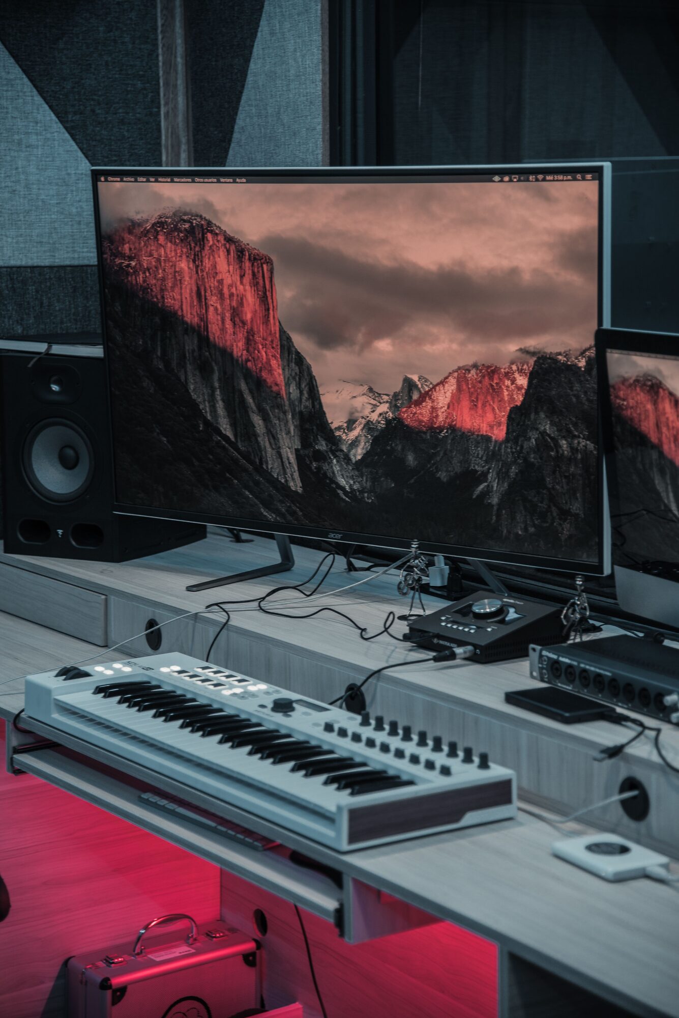 Clean home studio desk with monitor and keyboard