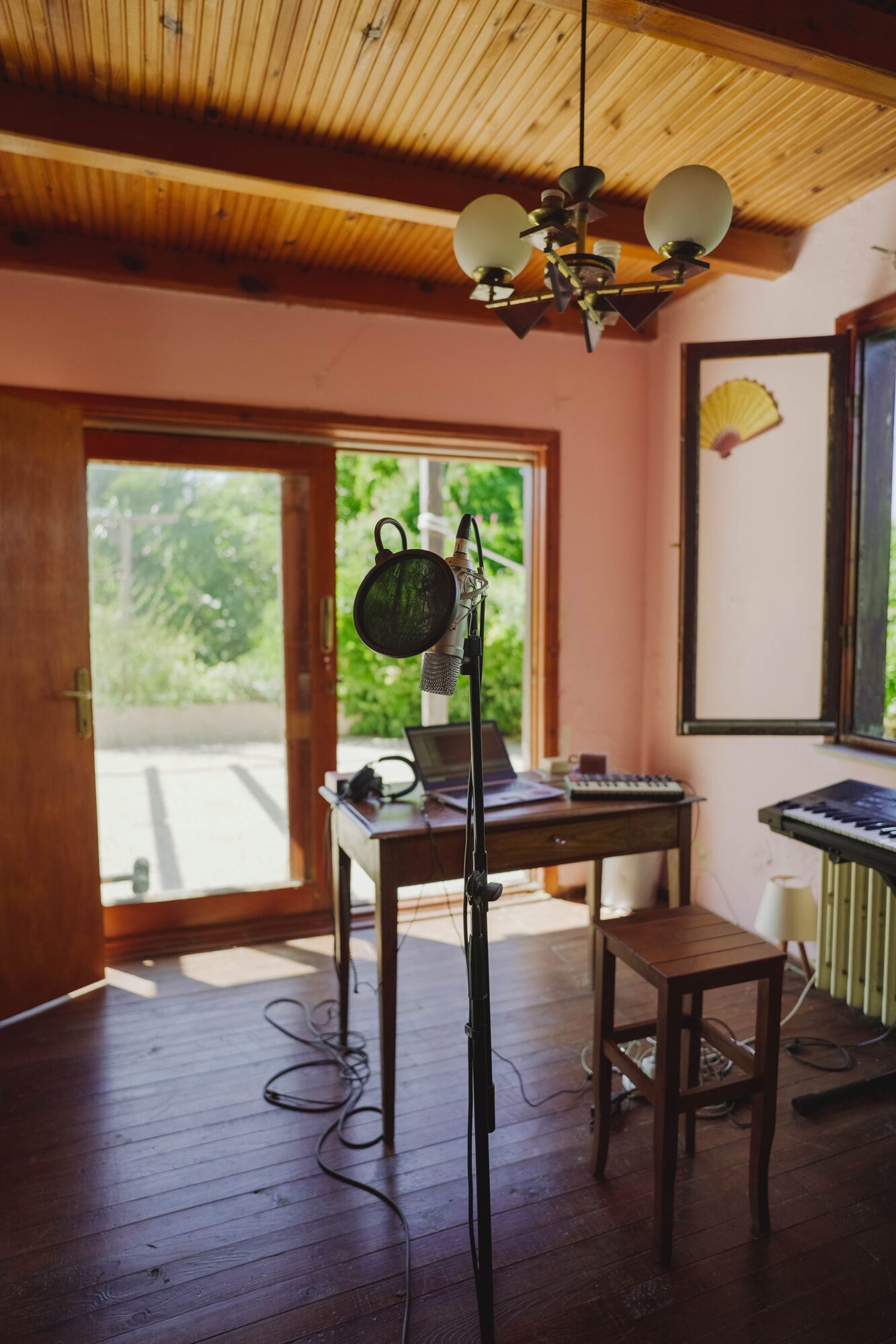 Sunlit wooden room with a microphone stand