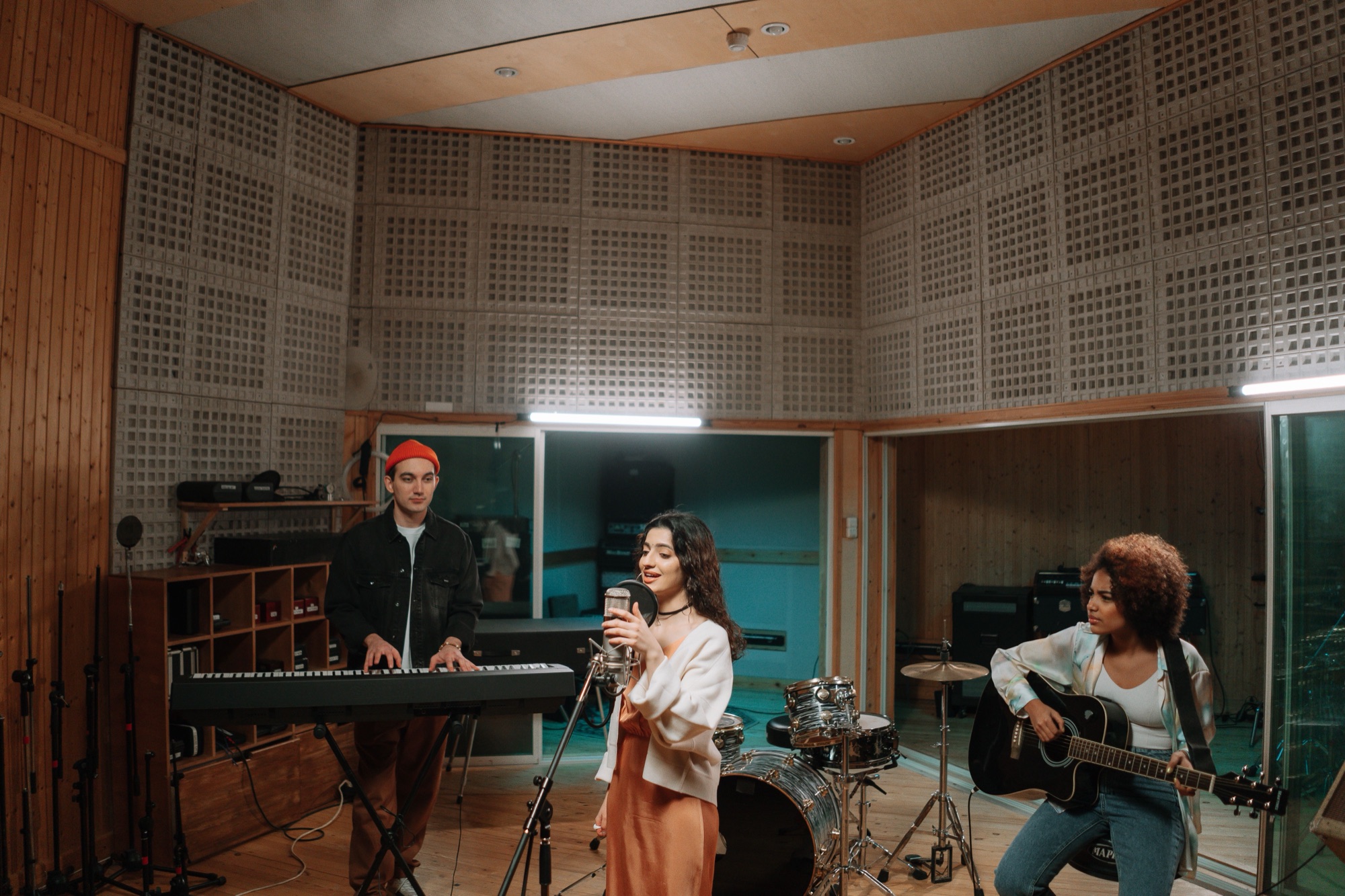 Band playing together in an acoustically treated live room