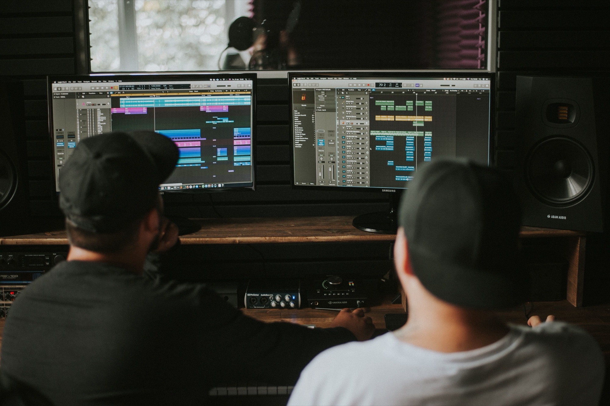 Two producers working at DAW screens