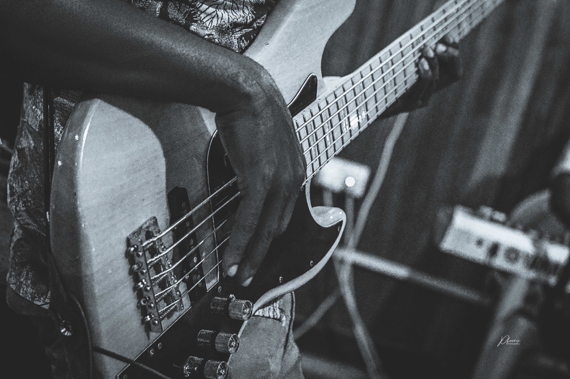 Hands playing bass guitar