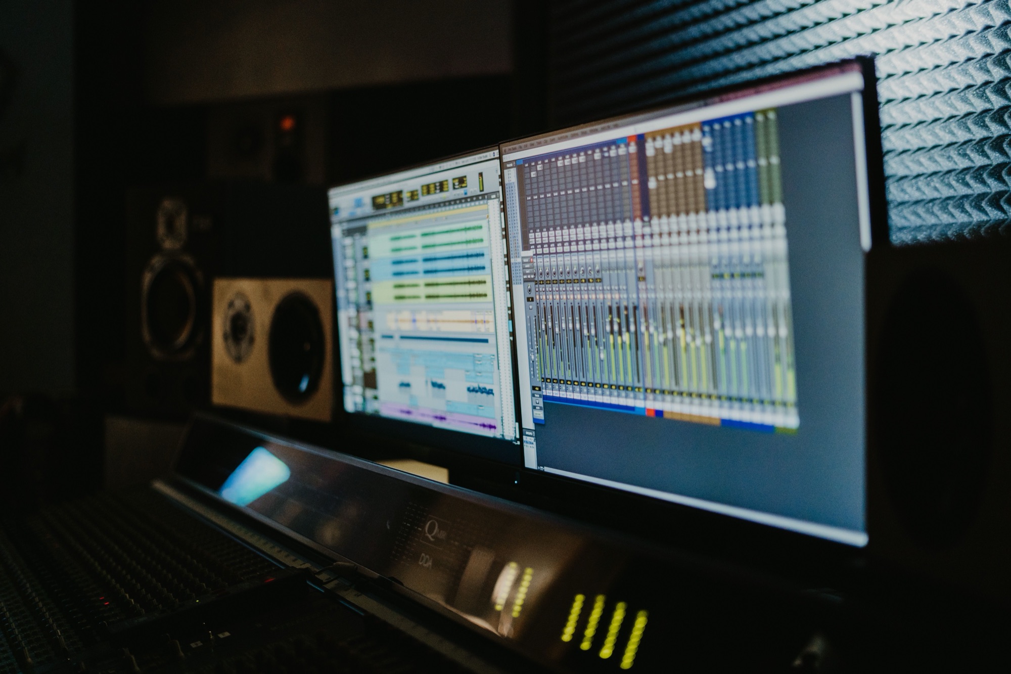 DAW session on dual monitors in a dark control room