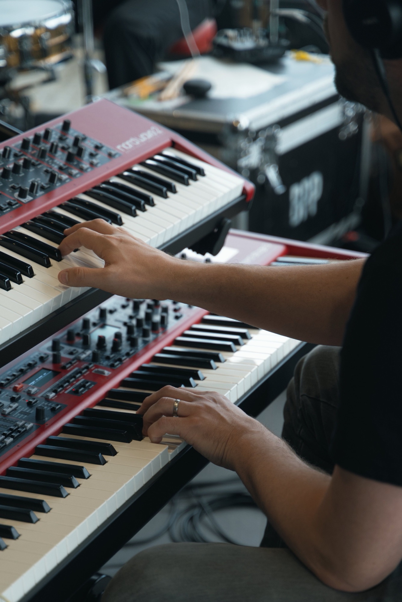 Keyboardist playing stacked keyboards