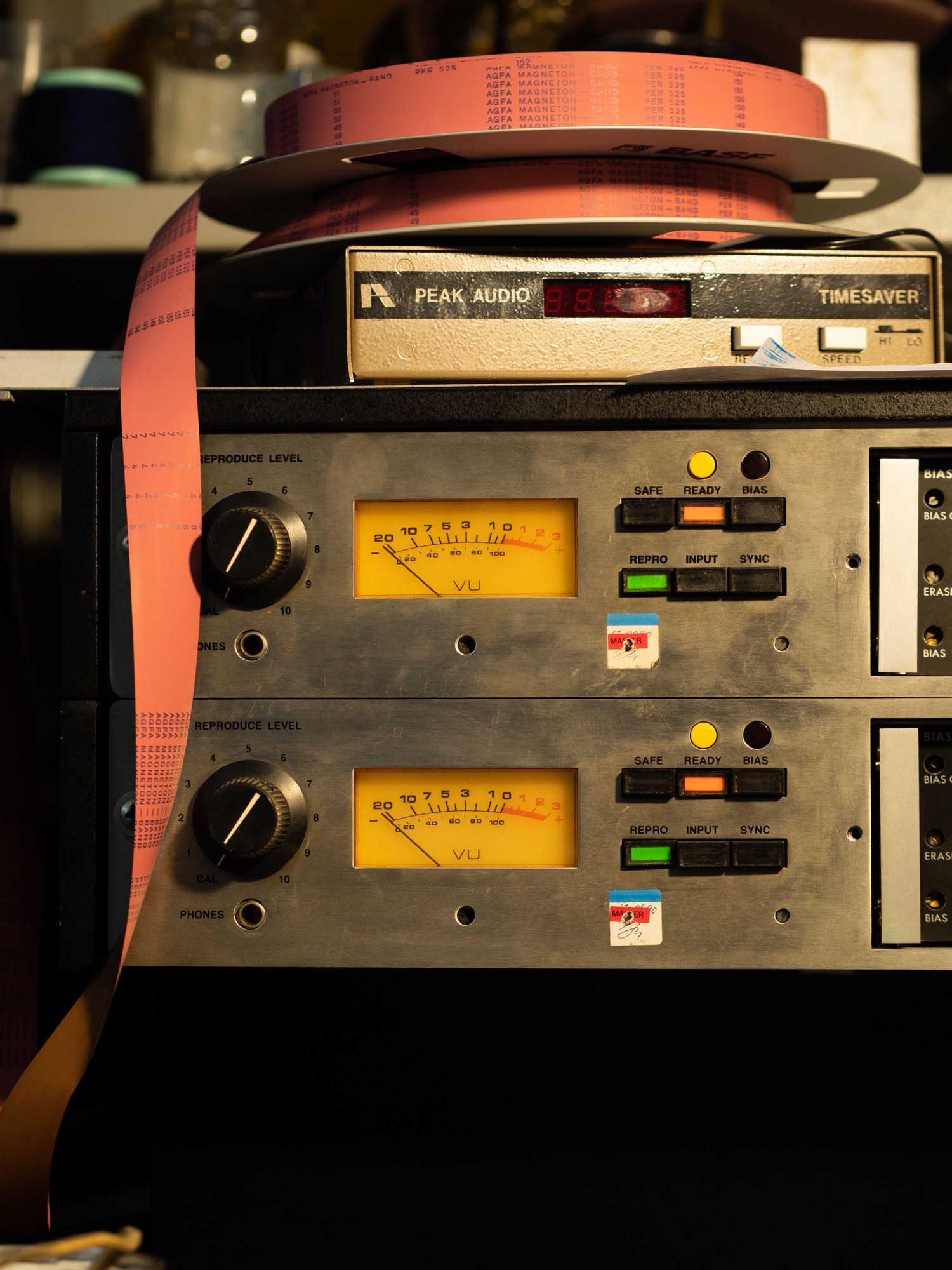 Tape machine spooling with glowing VU meters